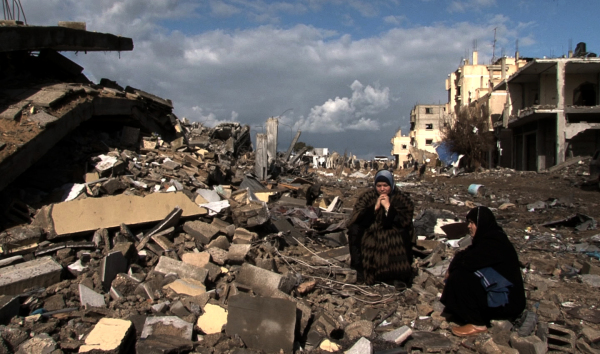 Foto di www.massimozamboni.it - donne siedono sulle macerie delle loro case dopo Piombo Fuso