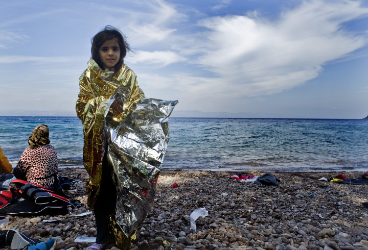October 5, 2015-Lesvos, North-east Aegean sea, Greece: Children refugees arrive into a small plastic and cheap boat to the coast of the Greek island Lesvos from the Turkish land (Maro Kouri)