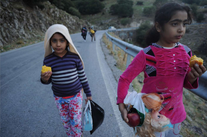 October 4, 2015 - Lesvos, Greece: Refugees children walk for hours  more than 30 km in order to find shelter in a camp. Thousands of refugees arrive to Lesvos coasts in plastic -and not safe- boats from the turkish coasts in order to travel towards north Europe (Maro Kouri)