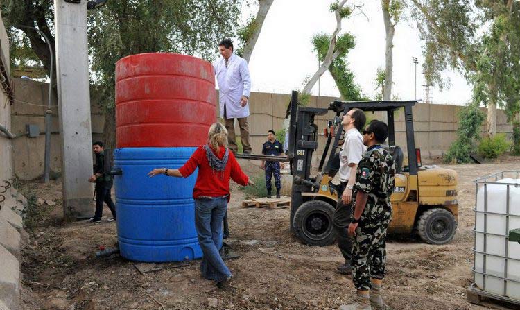 The UN in Iraq goes green: UNAMI staff installing a new biodigestor.