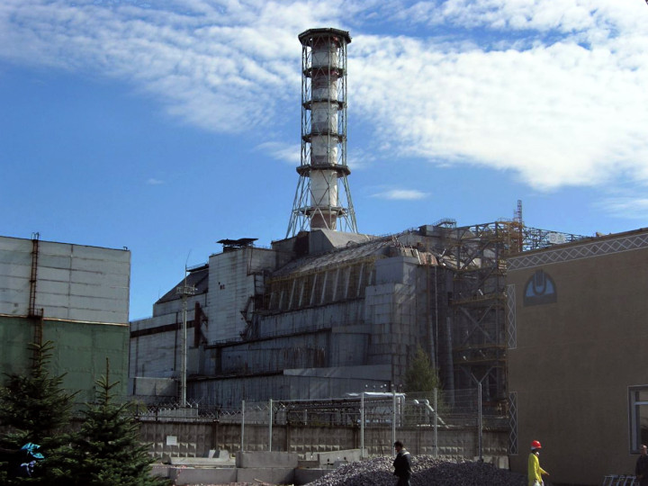 The Chernobyl reactor #4 building as of 2006, including the later-built sarcophagus and elements of the maximum-security perimeter.