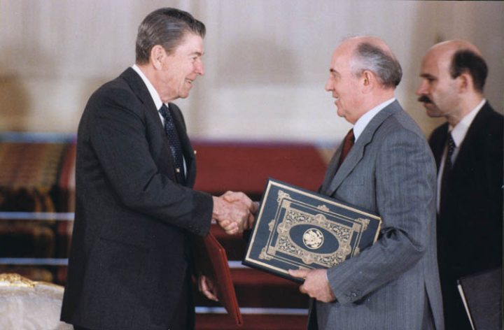 Reagan and Gorbachev shake hands after signing INF Treaty