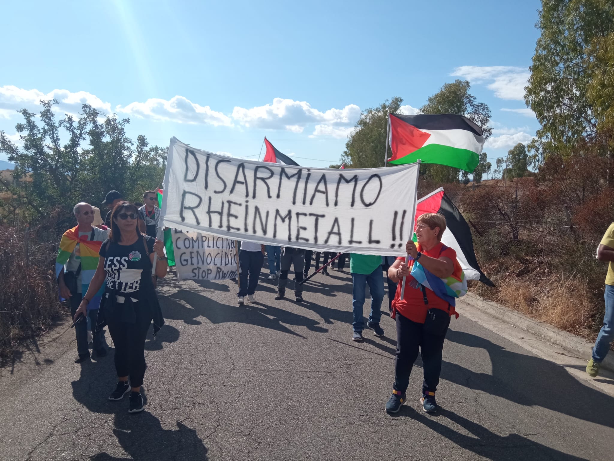 manifestanti con striscione: disarmiamo Rheinmetal