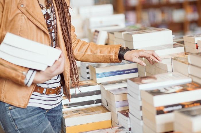 persona che guarda libri in libreria