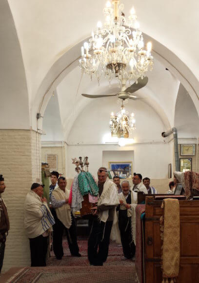 The author carrying a Torah in a synagogue in Iran