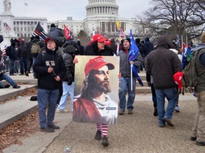 White #MAGA QAnon Jesus image carried during the Jan. 6, 2021, invasion of the Capitol. Photo by Tyler Merbler/Flickr/Creative Commons