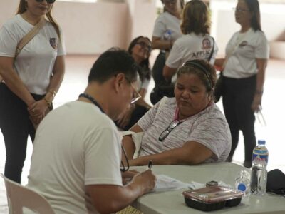 A doctor from Chacon General Hospital Inc. conducts a medical check-up during the medical mission.