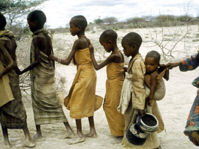 August 1992 - Berdale, Somalia - During the height of the Somalia famine, starving children line up to receive food at a feeding station in Berdale.  More than 300,000 people died of hunger.
Phot Credit: ANDREW HOLBROOKE/CORBIS