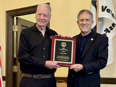 Gerry Condon (left) receives the US Peace Prize plaque from Michael Knox, Chair, US Peace Memorial Foundation.