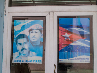 HOLGUIN, CUBA - JAN 28, 2016: Poster celebrating Hugo Chavez in Holguin, Cuba. It says: Glory to the brave peoples.