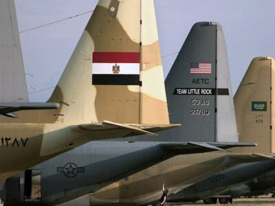 A US Air Force (USAF) ÒThe BlackjacksÓ 53rd Airlift Squadron (AS) 314th Airlift Wing (AW), Air Education Training Command (AETC), Little Rock Air Force Base (AFB), Arkansas (AR), C-130E Hercules aircraft crew member (center) inspects the tail section of his aircraft, that is parked between an Arab Republic of Egypt Air Force (EAF) C-130 (left) and a Royal Saudi Air Force (RSAF) C-130, in preparation for an inspection by Rodeo 98 Umpires during basic post-flight maintenance inspection competition portion of the USAF Air Mobility Command (AMC) sponsored Rodeo 98 airlift competition at McChord AFB, WA.