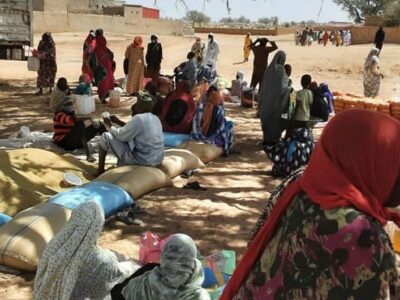 People in West Darfur collect emergency food rations.