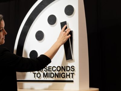 Bulletin President and CEO Alexandra Bell moves the minute hand on the Doomsday Clock.