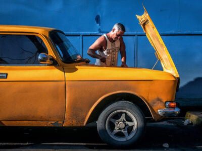 An unknown driver fixes his old russian made Moskvitch 2140 at a Gas Station near Aguada de Pasajeros, Cienfuegos, Cuba